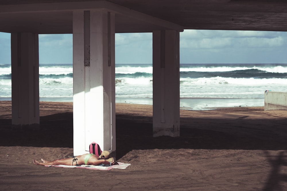 woman lying under bridge