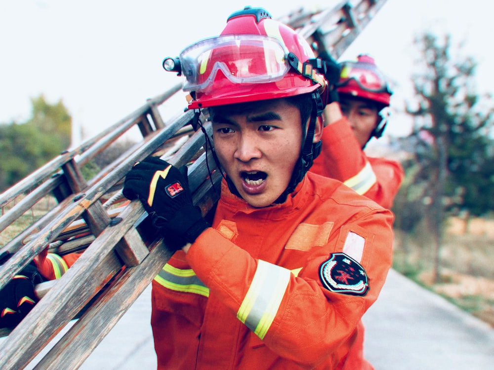 men carrying ladder