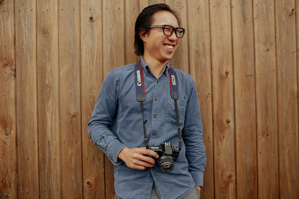 smiling man holding camera