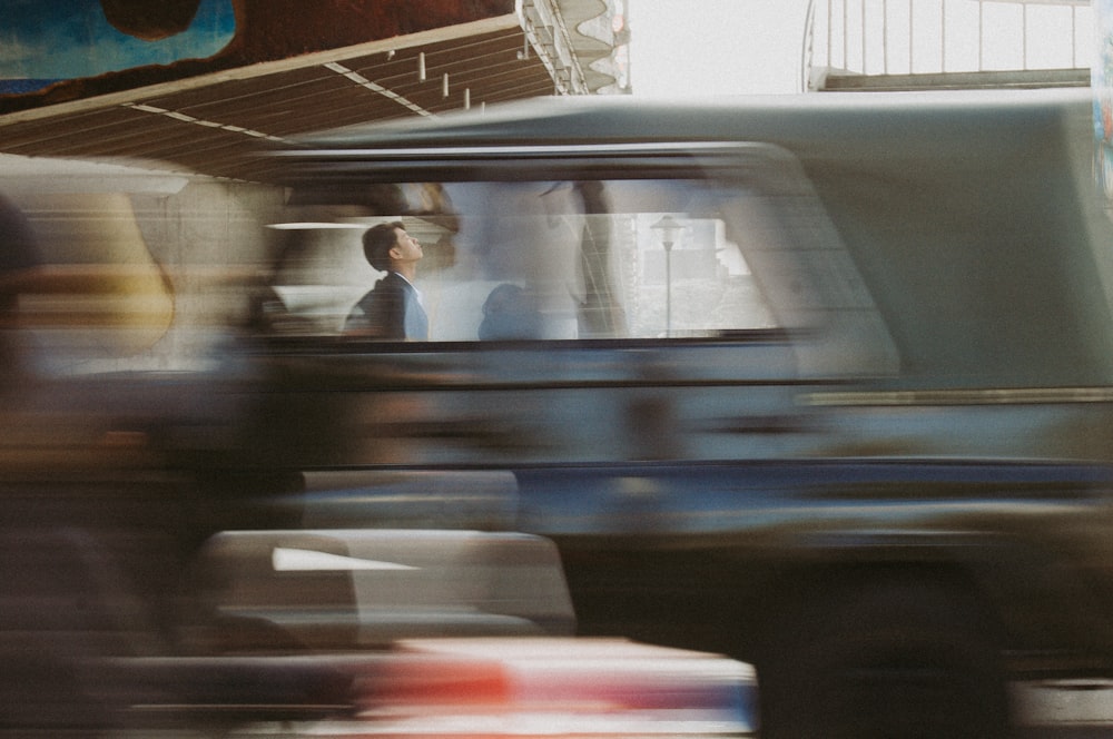 a blurry photo of a man driving a truck