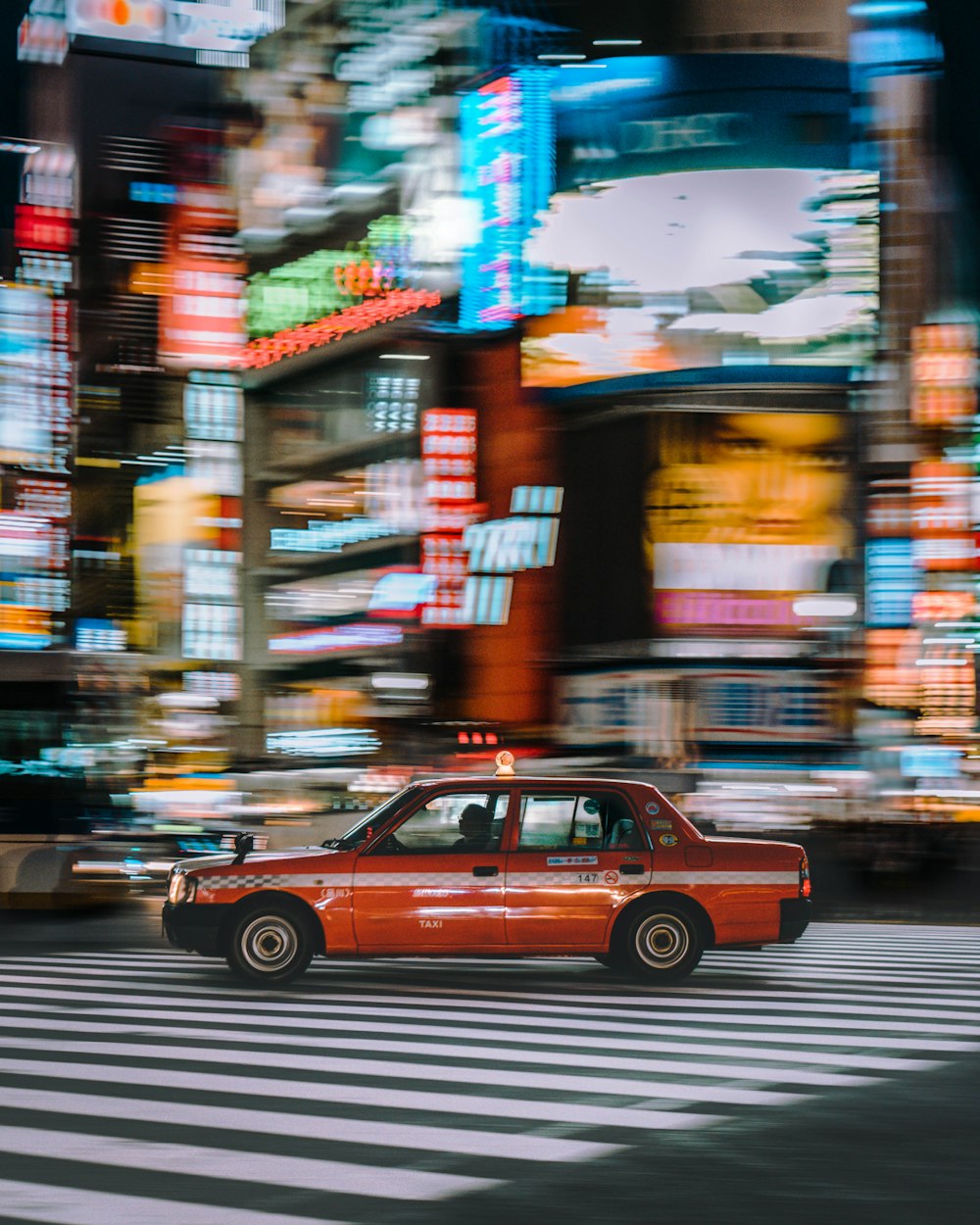 red four door sedan car on street