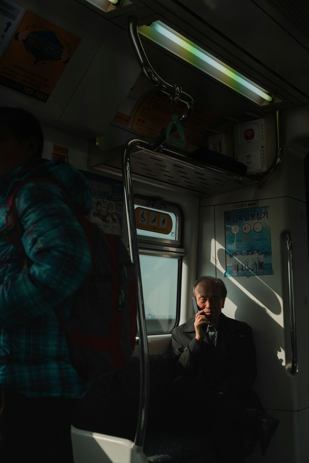 man sitting while holding phone