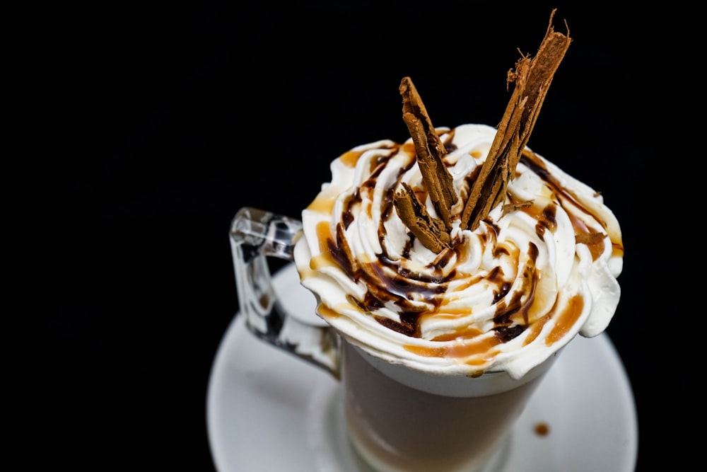 clear glass mug with whip cream on top