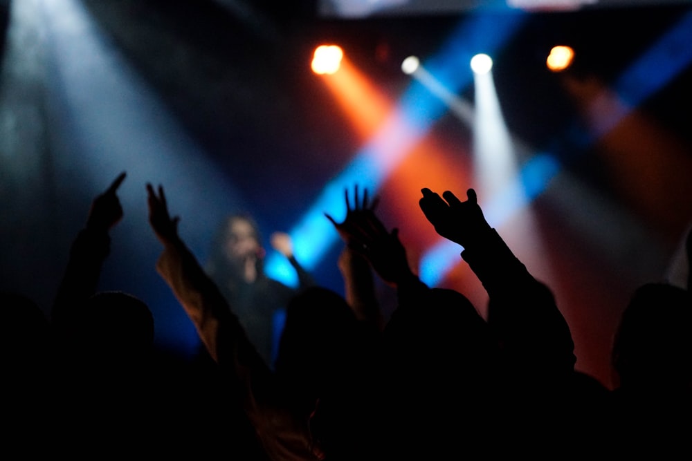 group of people raising hands