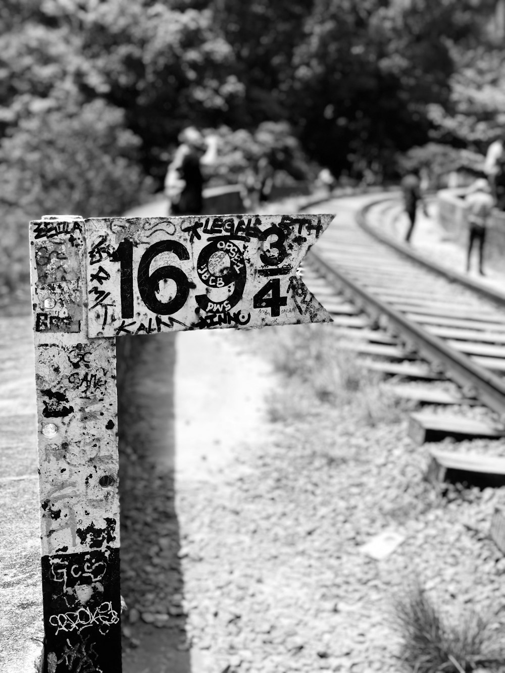 grayscale photo of train 169 3/4 signage