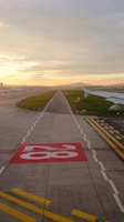 A wide shot of a newly constructed modern airport runway at dawn.