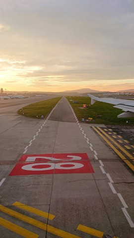 A wide shot of a newly constructed modern airport runway at dawn.