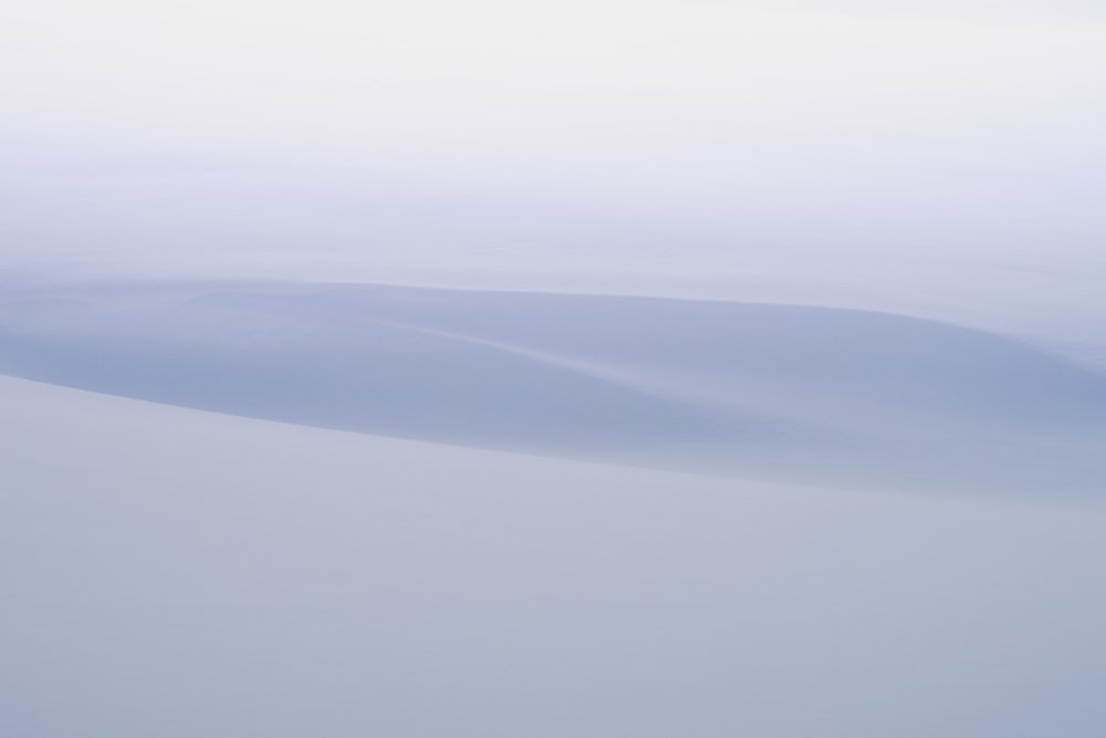 a person riding skis down a snow covered slope