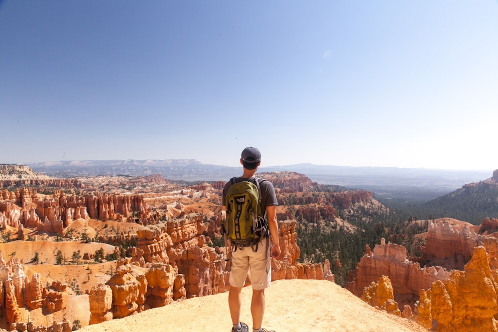 man standing on cliff during daytime