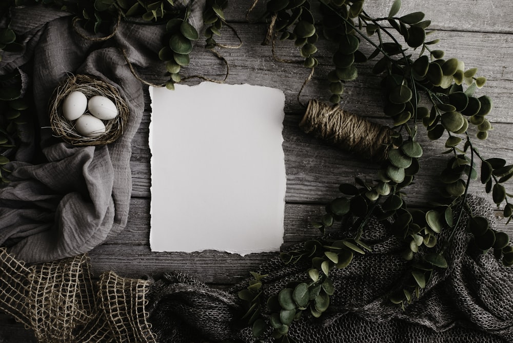 an easter flatlay of white paper and easter eggs in a nest