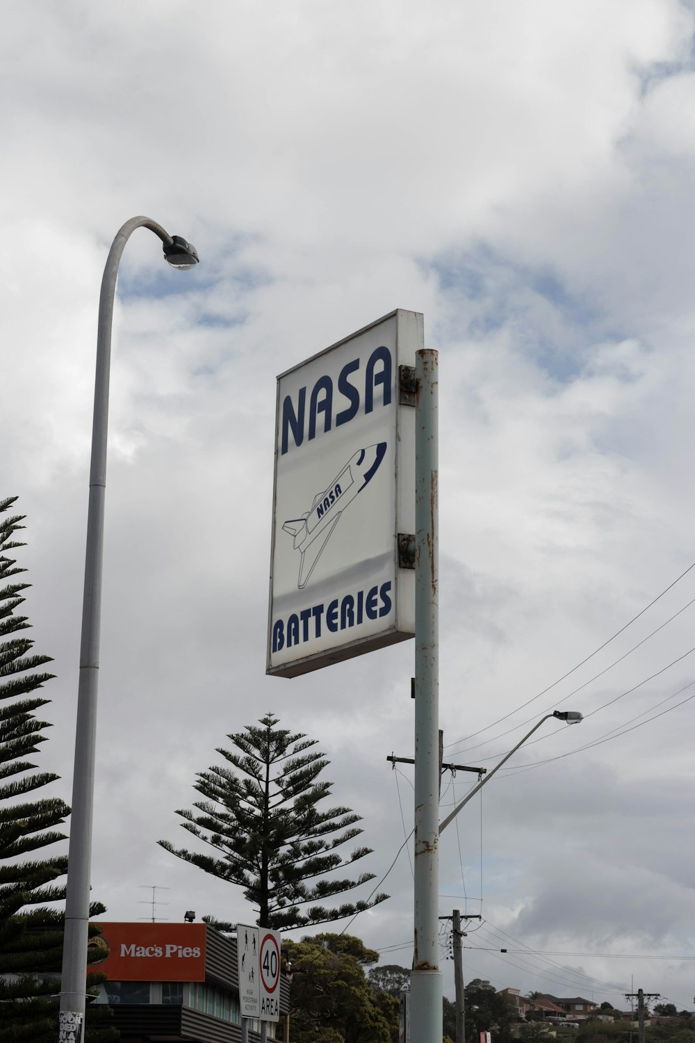 white and blue Nasa Batteries signboard