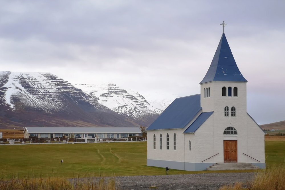 white and blue church across mountain