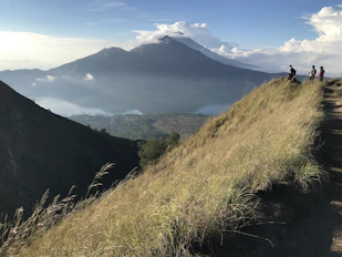 people standing at the peak of mountain