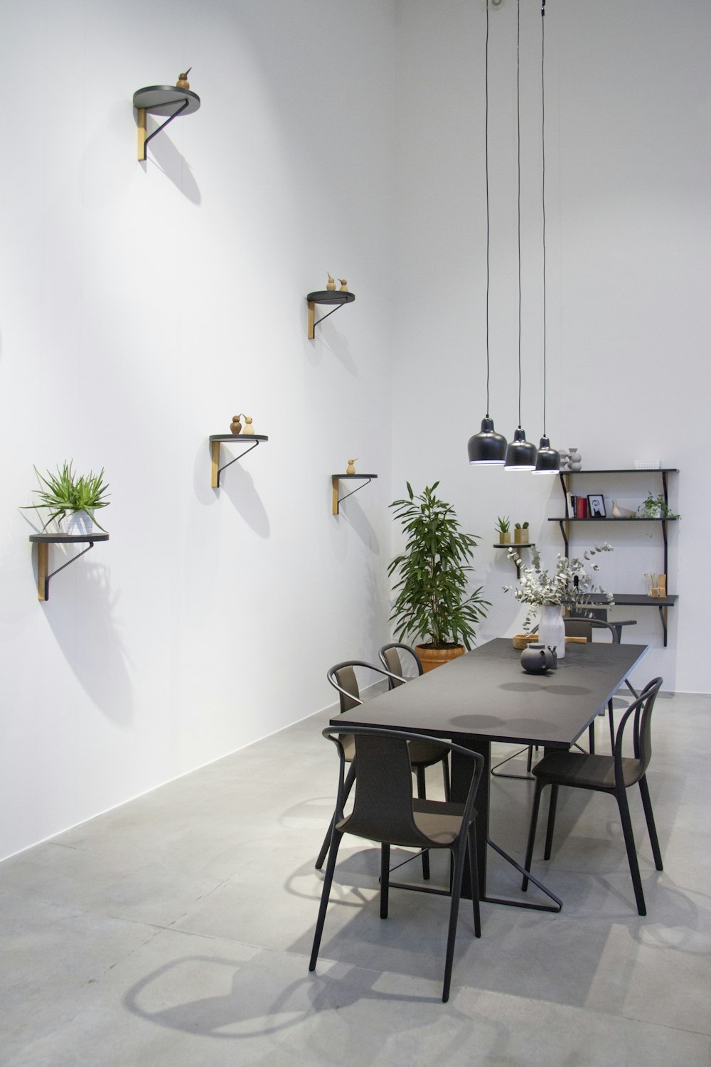 rectangular black wooden table with chairs