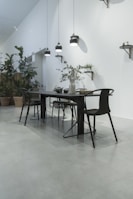 A modern dining area with a sleek dining table and chairs.