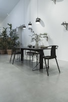 A modern dining area with a sleek table and elegant chairs.
