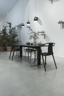 A modern dining area with a sleek table and elegant chairs.