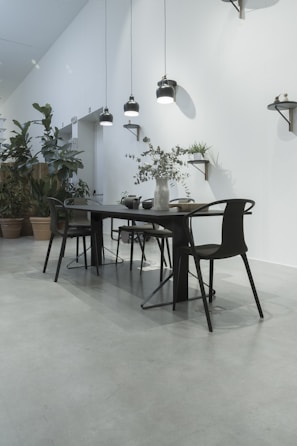 A modern dining area with a sleek dining table and chairs.