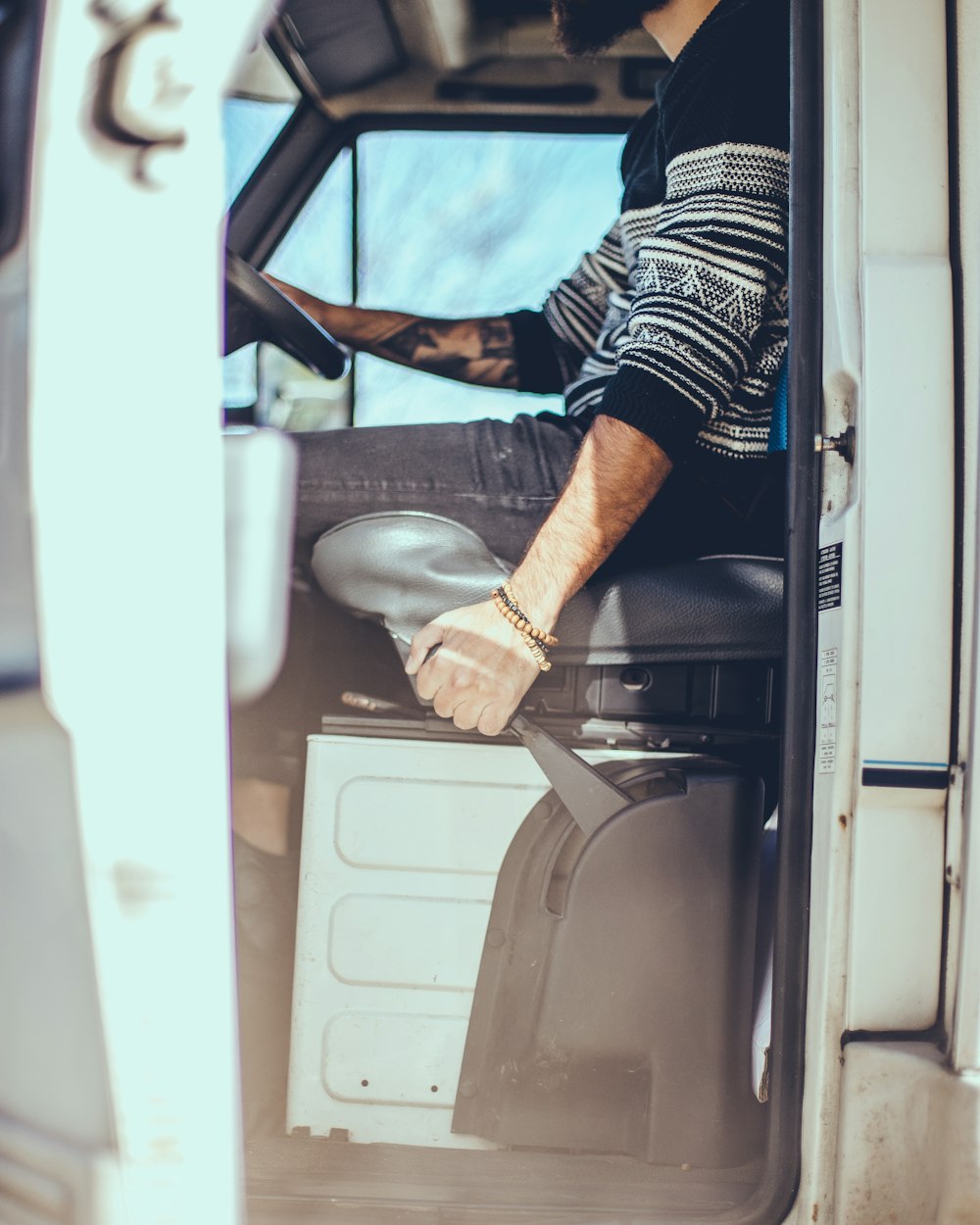 person holding vehicle handbrake