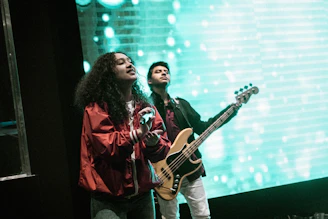 man playing brown bass guitar