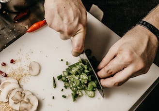 person slicing vegetable