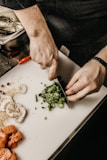 chef person slicing vegetable