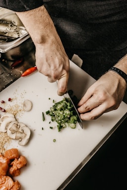 person slicing vegetable