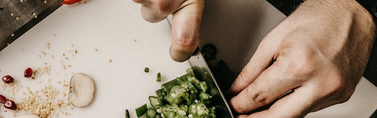 person slicing vegetable