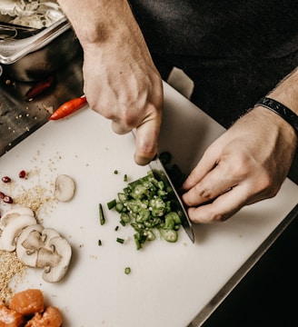 person slicing vegetable