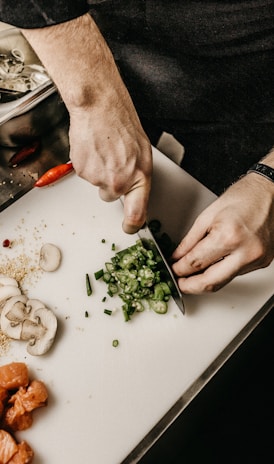 person slicing vegetable