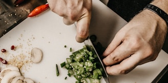 person slicing vegetable