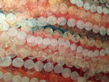 Abstract string art installation with overlapping circles in warm tones.