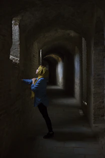 Muslim woman leaning hand on wall
