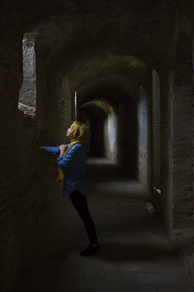 Muslim woman leaning hand on wall