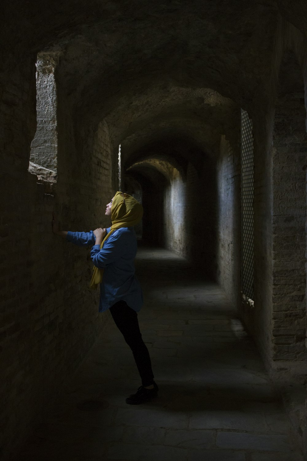 woman leaning hand on wall