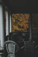 Warm-toned photograph of a weathered front porch bathed in golden afternoon light.