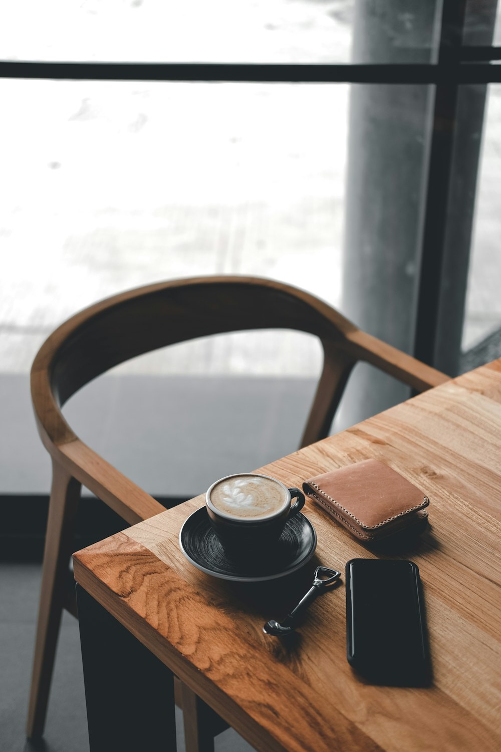 coffee in black cup on brown wooden table