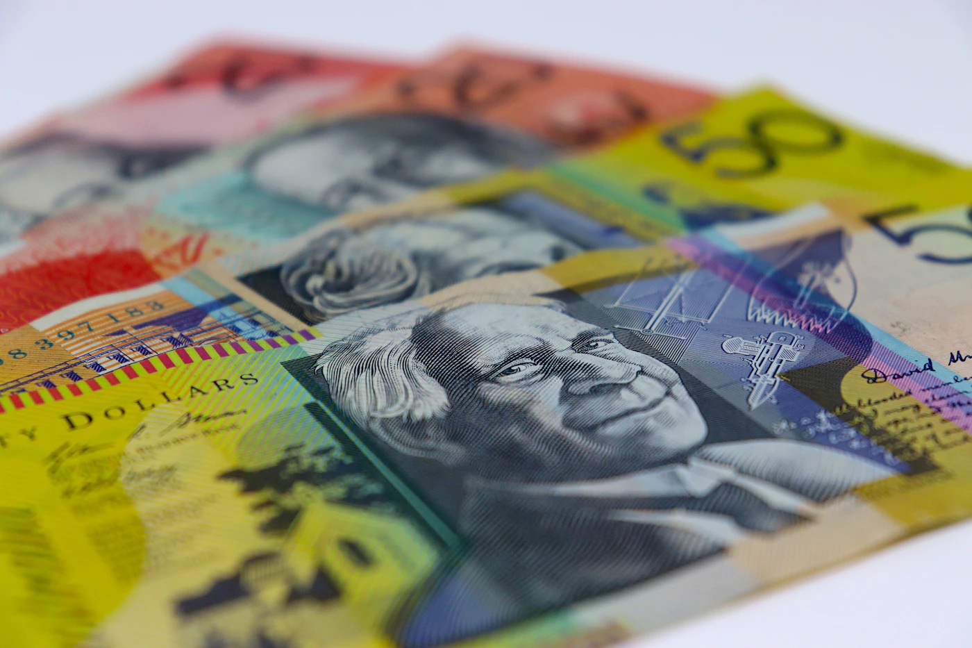 Australian $50 and $20 banknotes fanned out on a white background