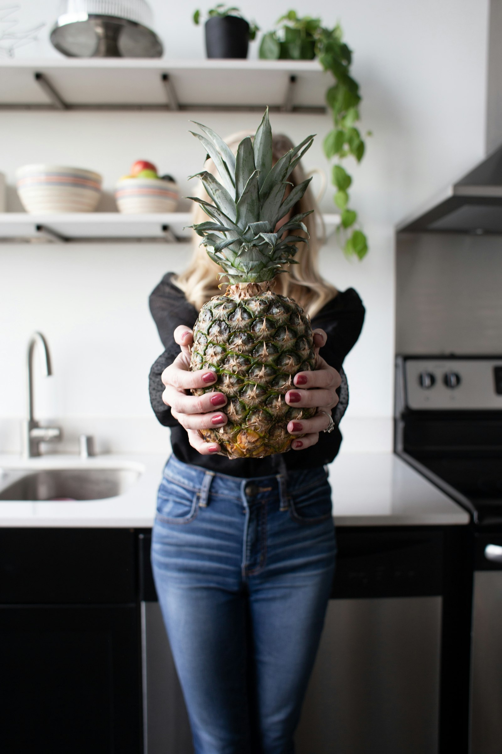 Canon EF 28mm F1.8 USM sample photo. Woman holding pineapple photography