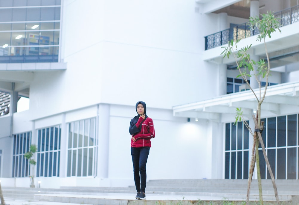 woman standing near building