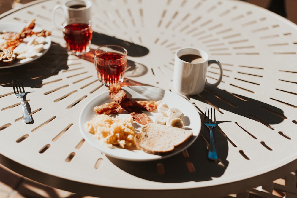 shallow focus photo of round white ceramic plate on round table