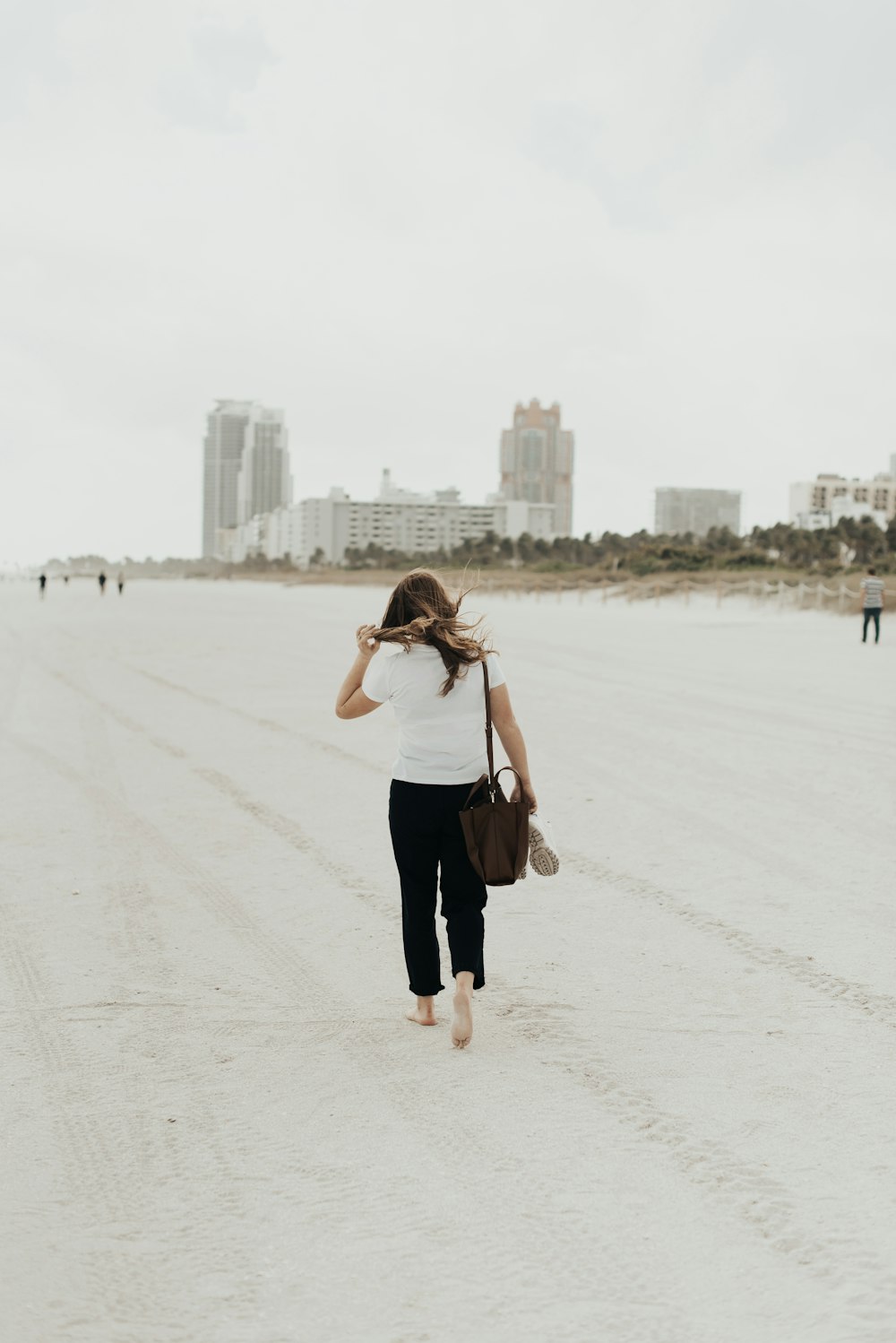 woman walking on white sand