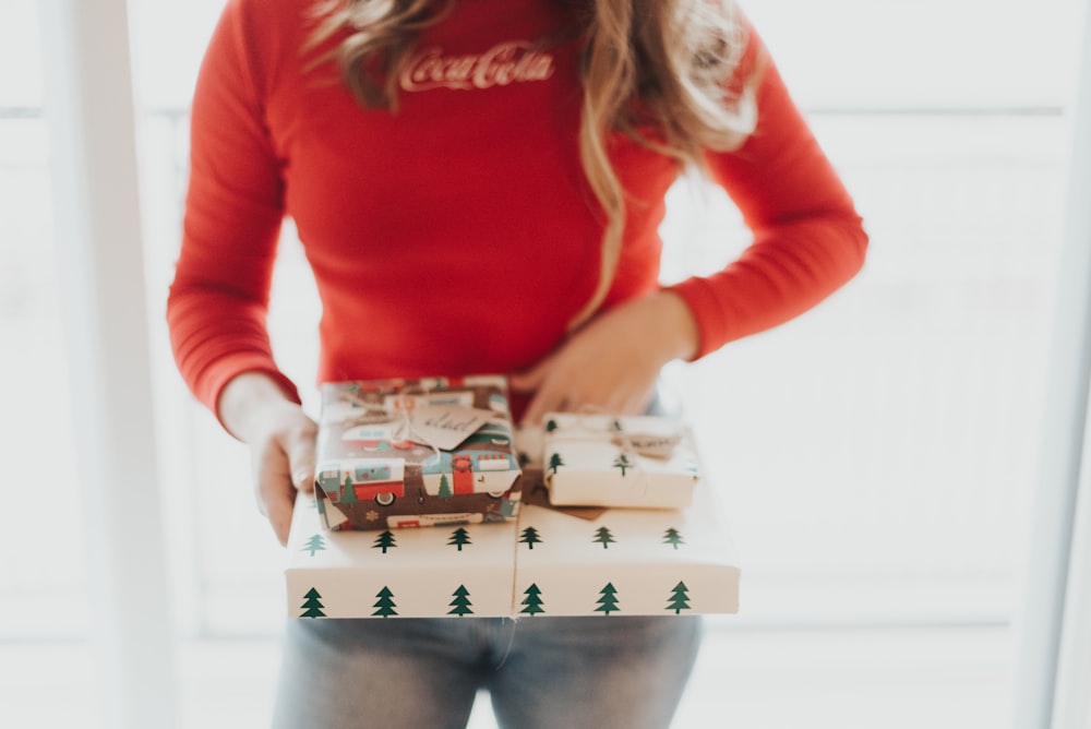 person holding white and green box