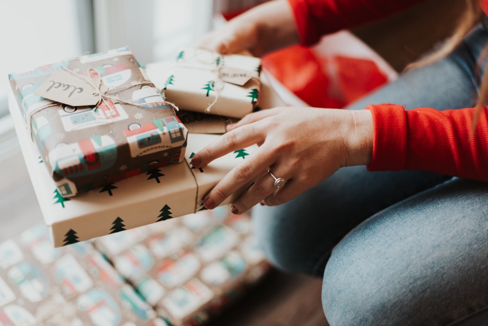 person holding giftboxes