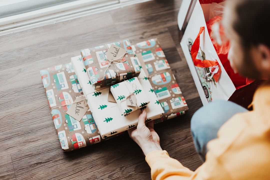 person holding gift boxes