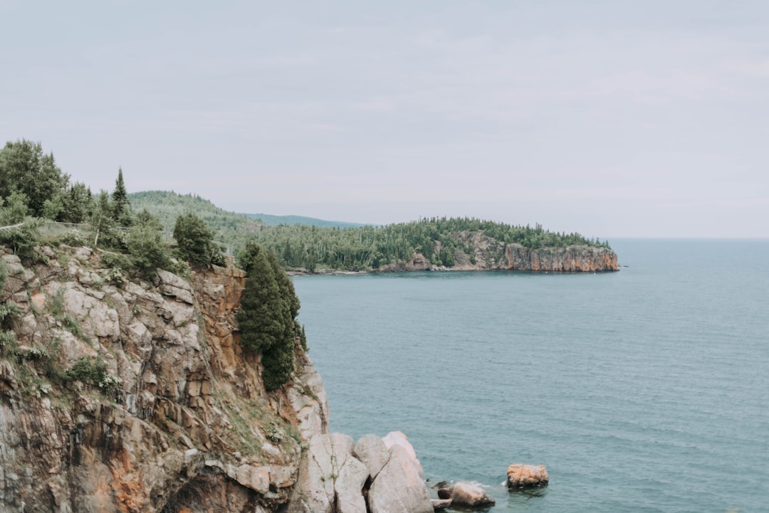 cliff beside body of water