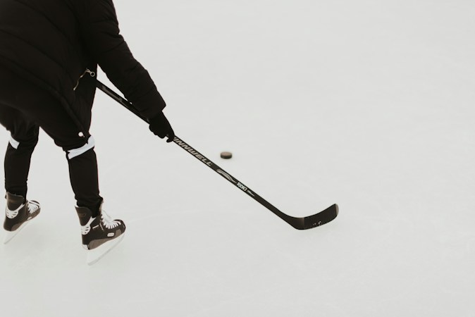 A skater working on stick handling drills during an instructional hockey clinic