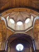 Close-up of wooden beams and geometric patterns in a dome structure.