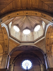 Interior view of a dome showing natural wood beams and soft lighting.