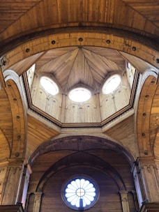 Interior view of a dome showing wooden beams and soft, inviting lighting.